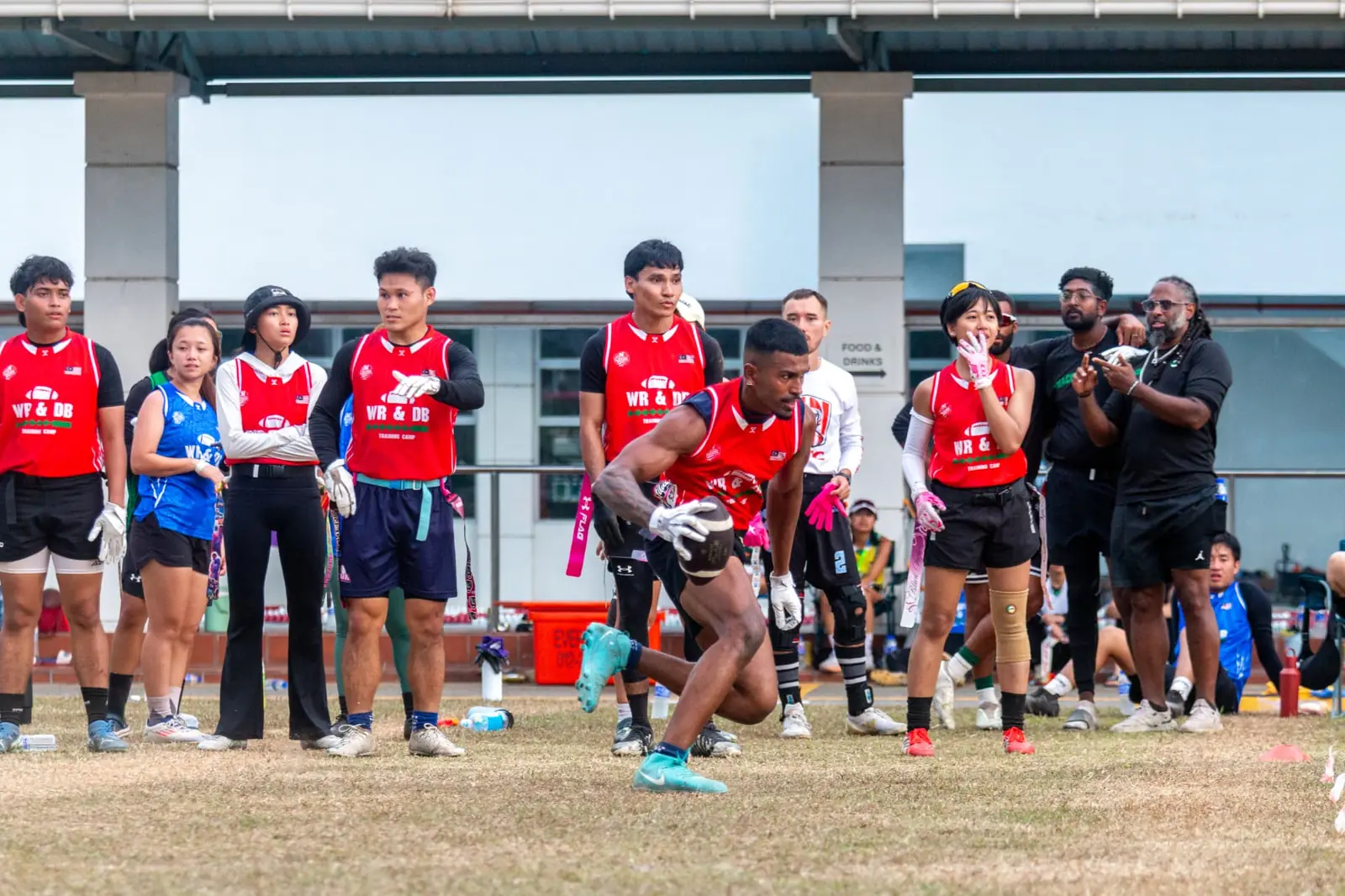 Coaches and players at a flag football training camp